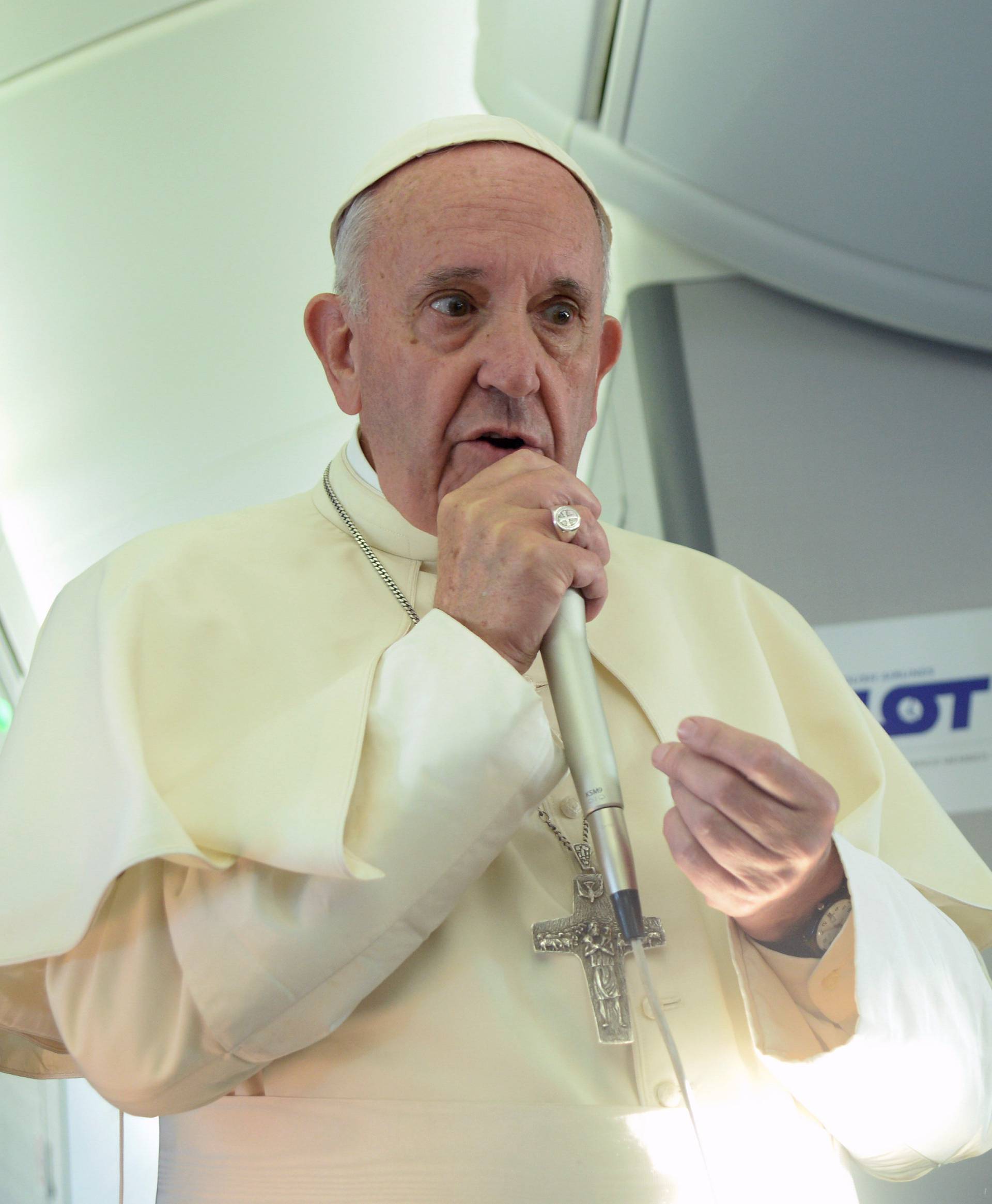 Pope Francis speaks to journalists during a press conference on the plane after his visit to Krakow for the World Youth Days 