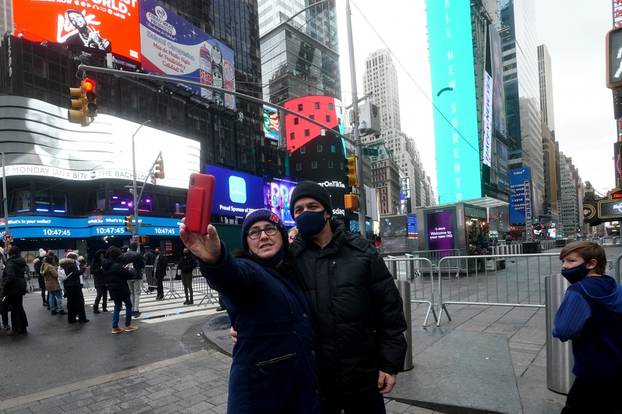 People take a selfie in Times Square ahead of New Year