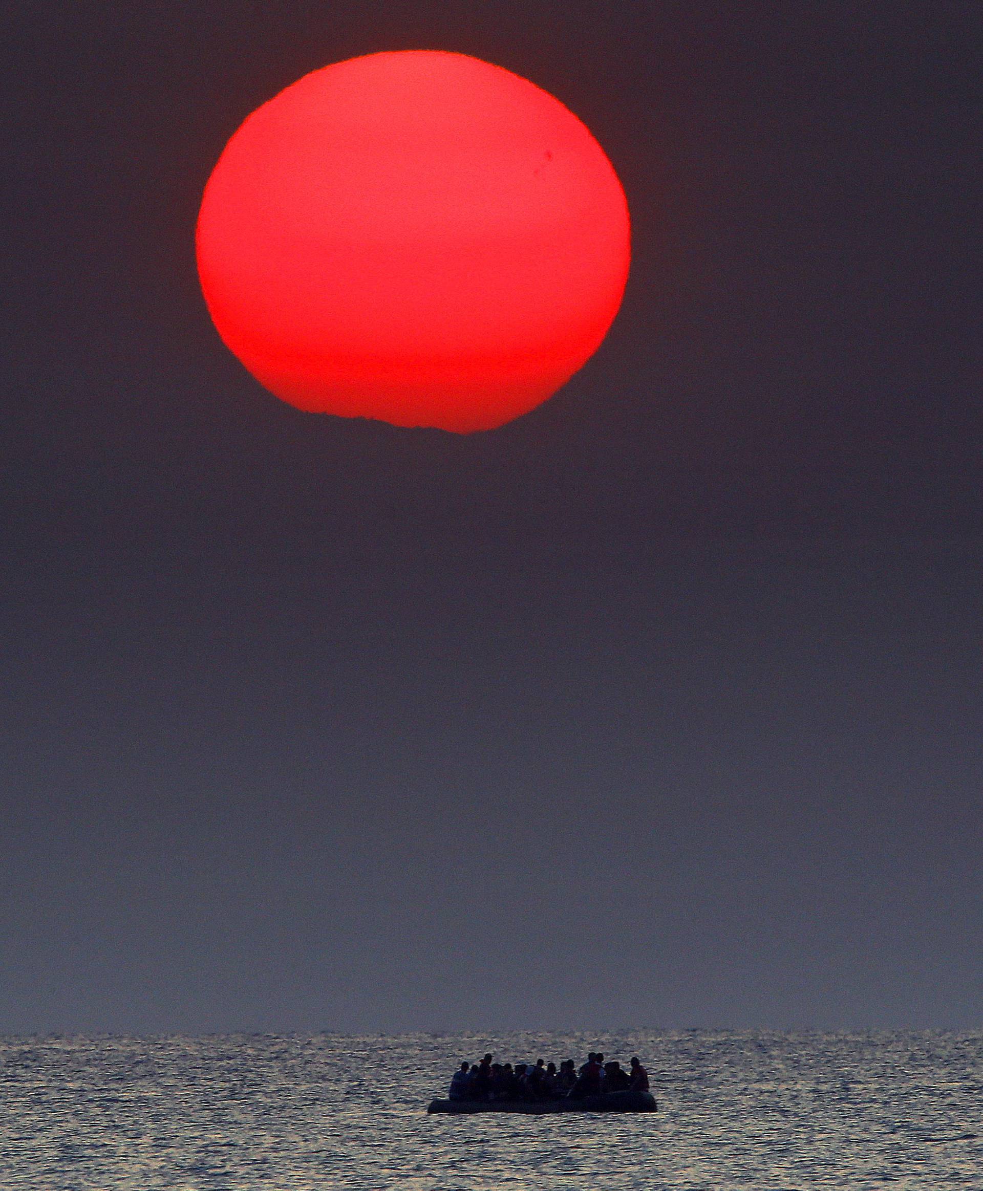 Syrian refugees on a dinghy drift in the Aegean sea off the Greek island of Kos in Greece 