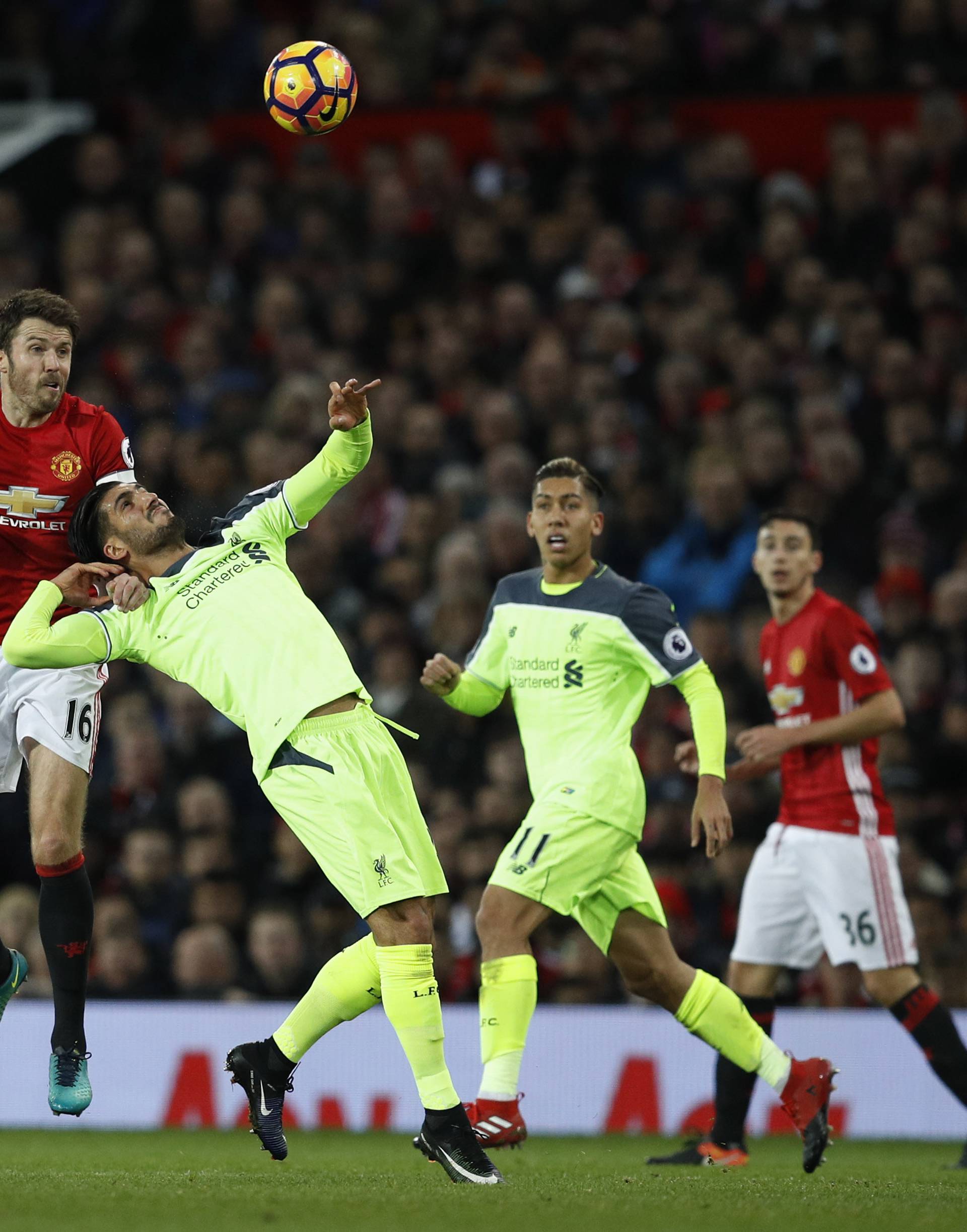 Manchester United's Michael Carrick in action with Liverpool's Emre Can