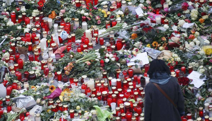 Flowers and candles are placed near the Christmas market in Berlin