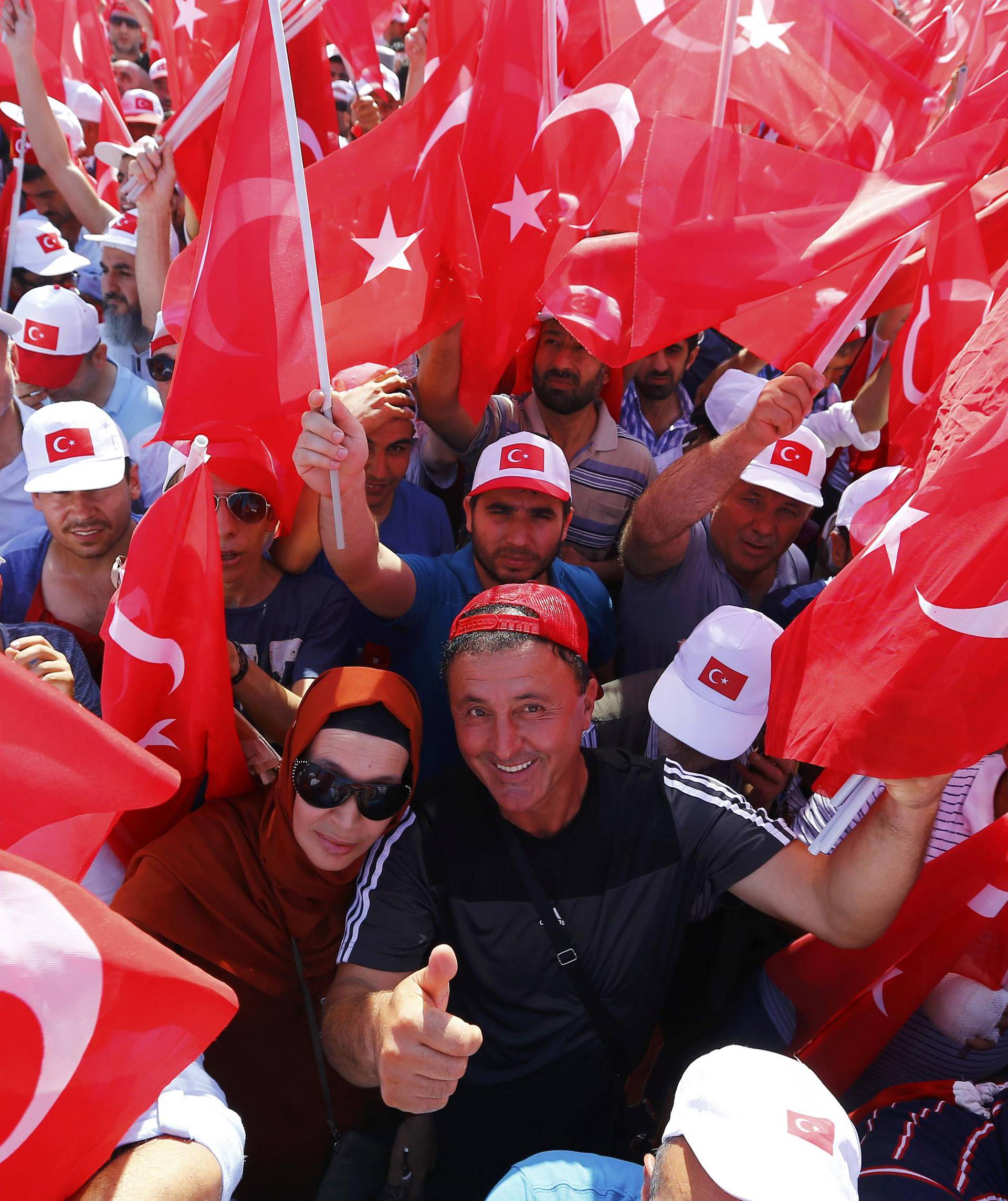 People hold Turkey's national flags during the Democracy and Martyrs Rally in Istanbul
