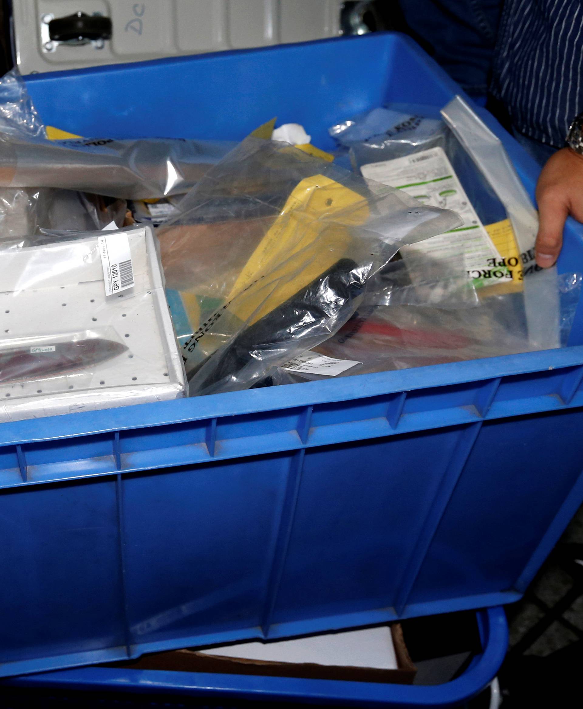 A bloodstained knife is pictured among other evidence outside the High Court as police carry it away after the double murder trial of British former banker Rurik Jutting in Hong Kong 