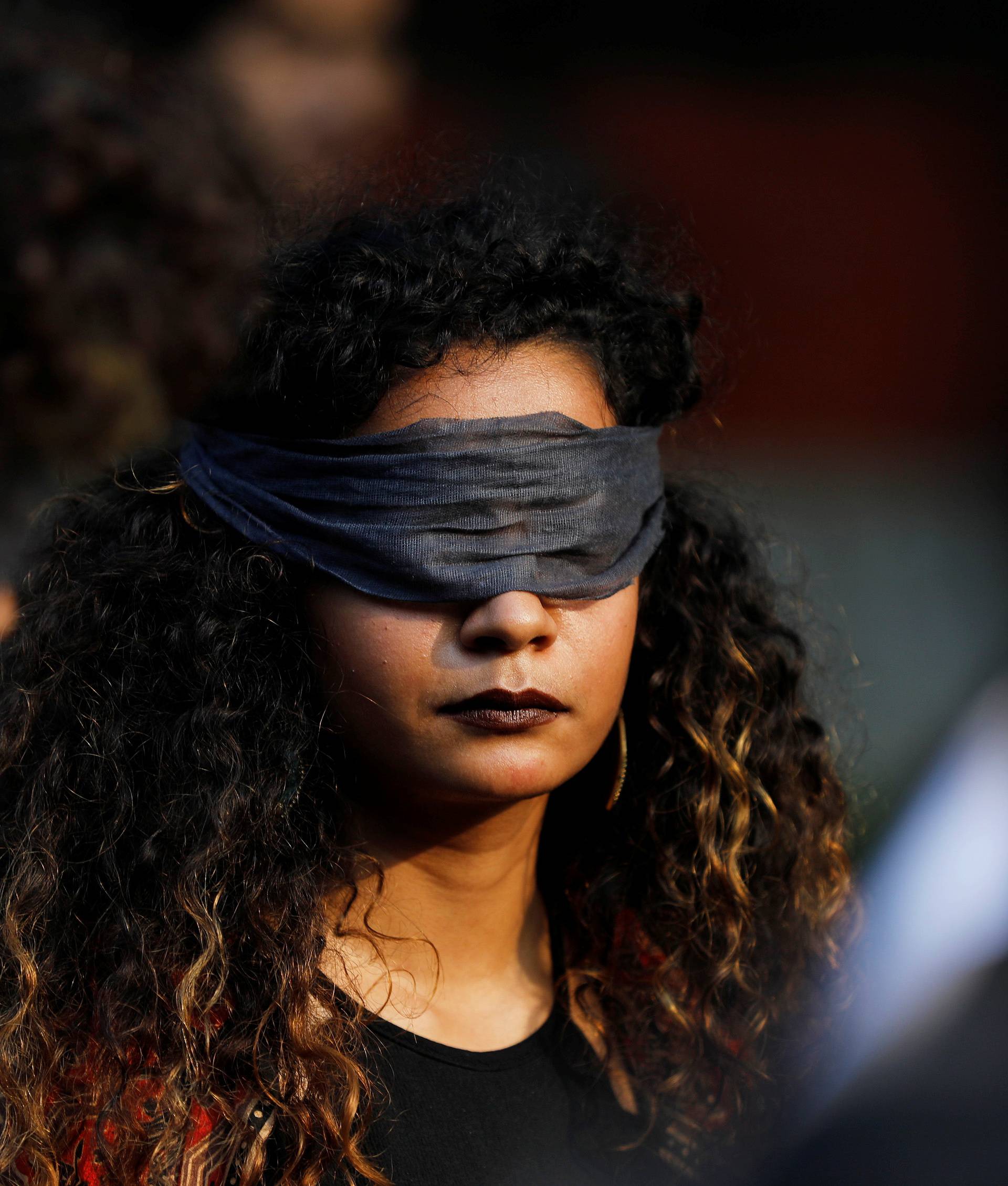 A protestor wearing a blindfold takes part in a protest in solidarity with rape victims and to oppose violence against women in India, in New Delhi