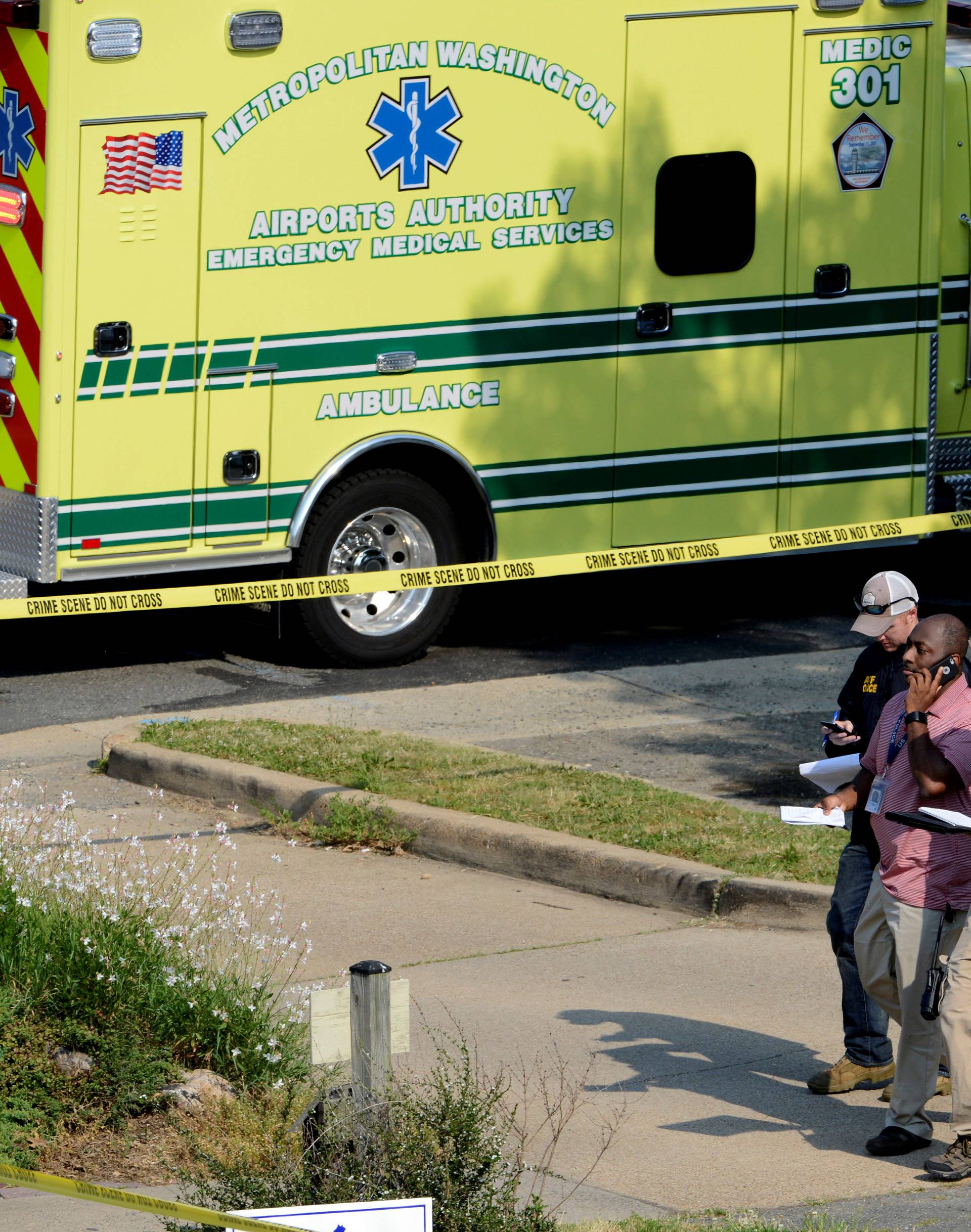 Police and investigators walk at the scene where shots were fired during a congressional baseball practice in Alexandria