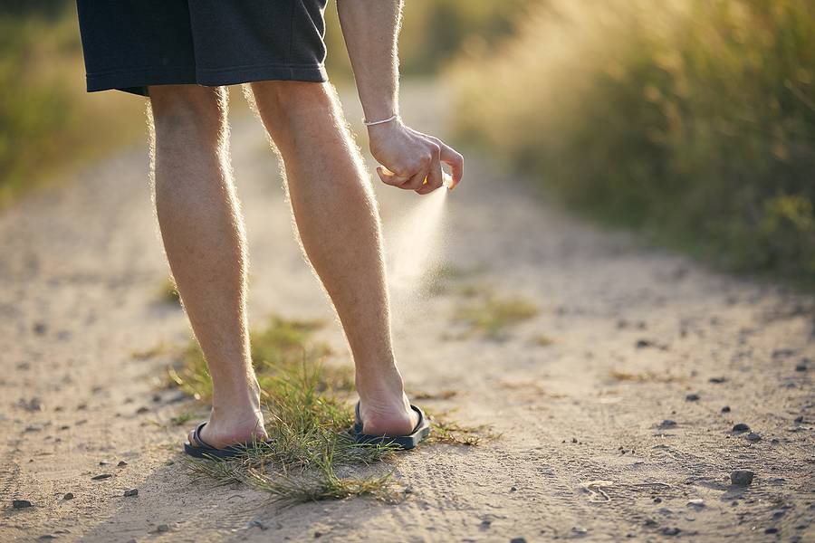 Prevention Against Mosquito Bite. Man Applying Insect Repellent 