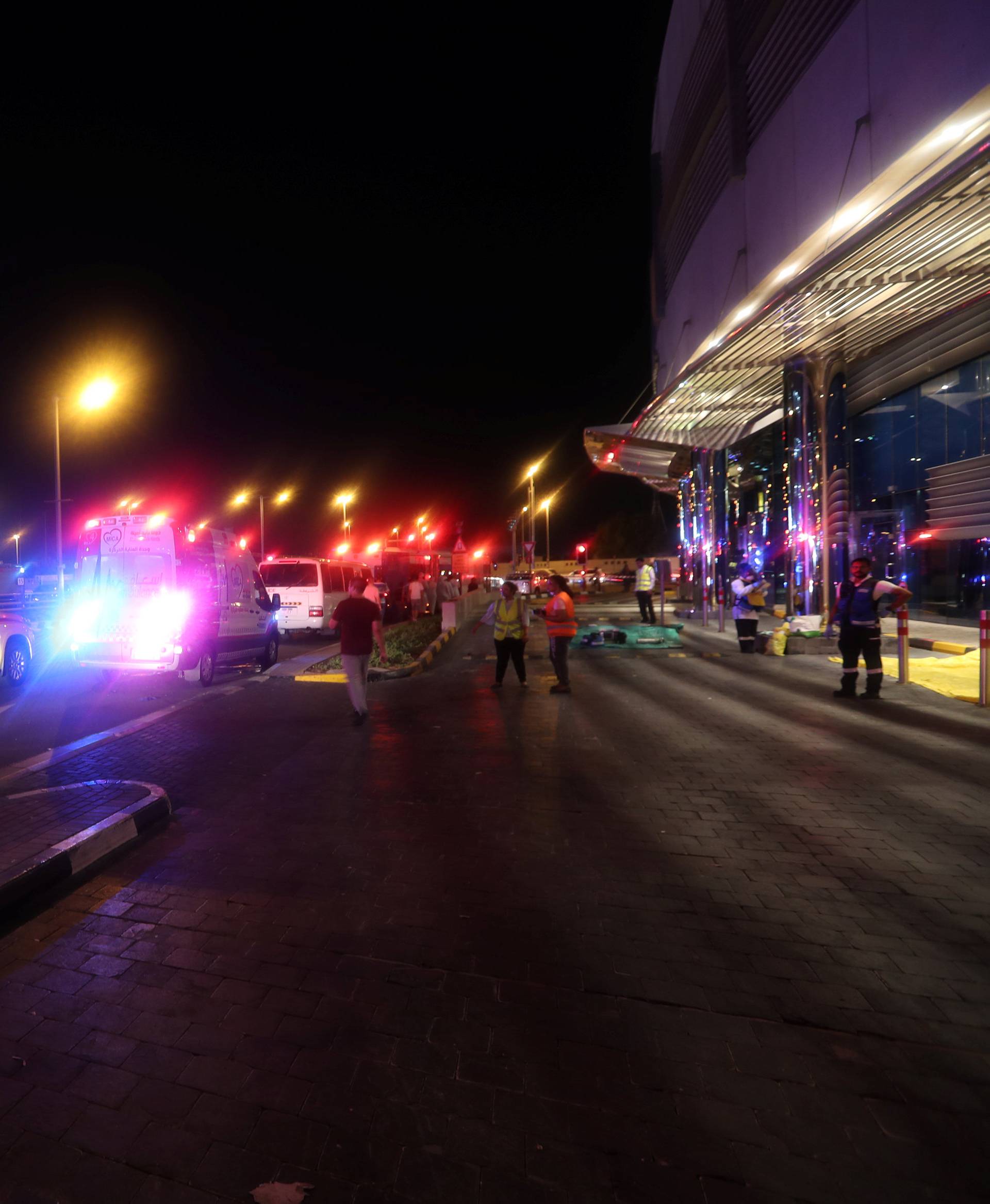 Dubai Emergency Response teams and Dubai police are seen on the street near Dubai's Torch tower residential building in the Marina district, Dubai