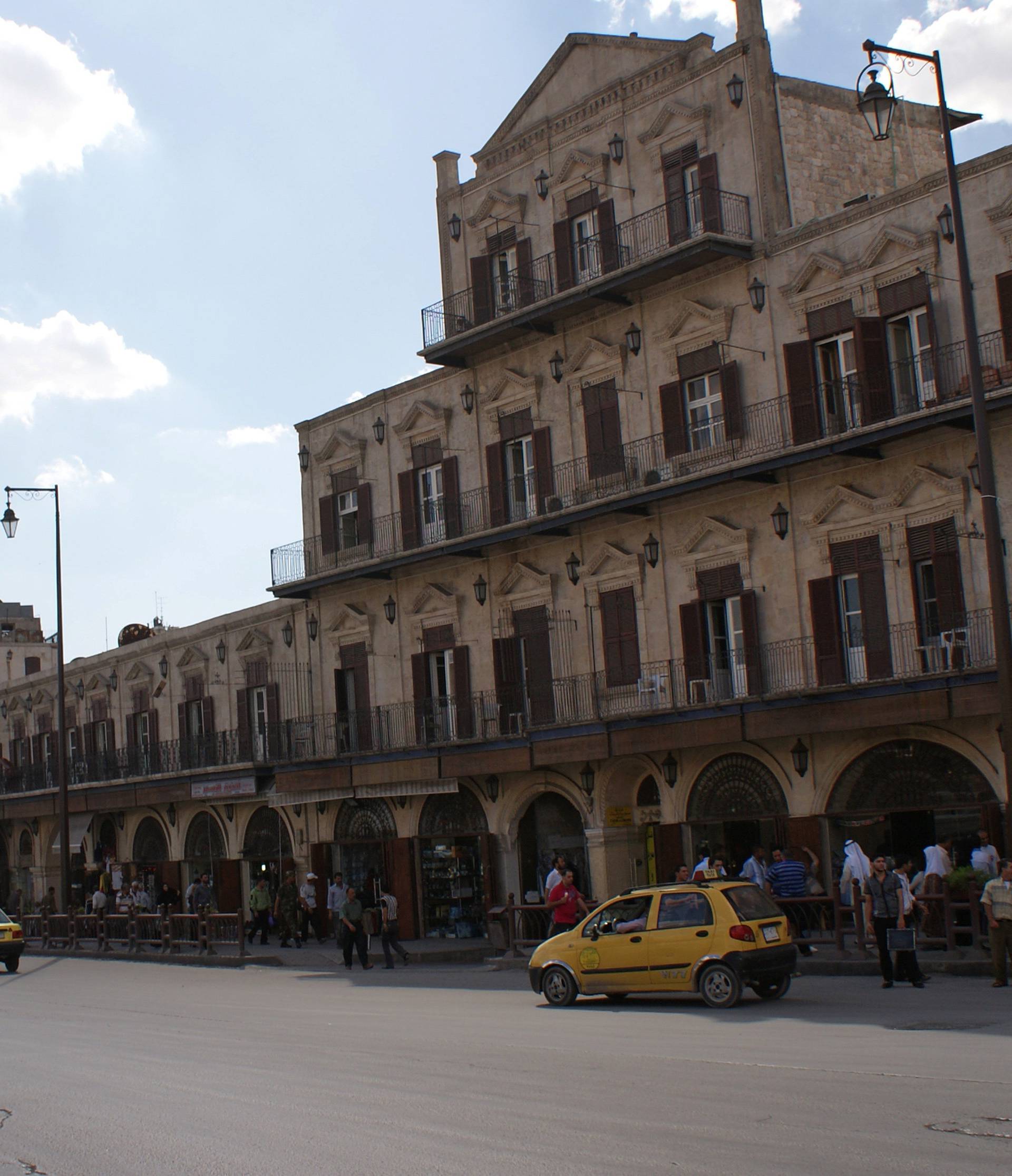 People walk near Aleppo's Bab al-Faraj Clock Tower