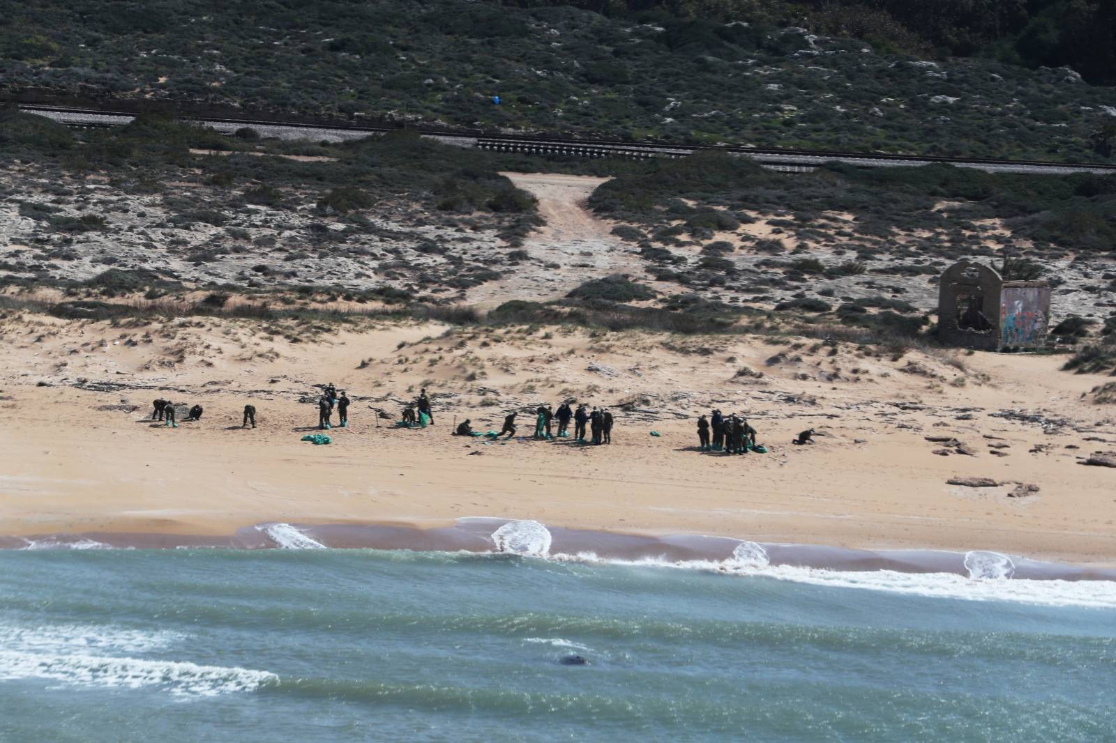 Israel's beaches blackened by tar after offshore oil spill