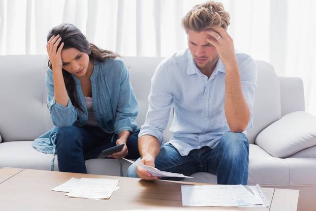 Desperate,Couple,Doing,Their,Accounts,In,The,Living,Room