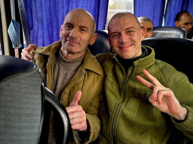 Ukrainian POWs are seen after a swap at an unknown location in Ukraine