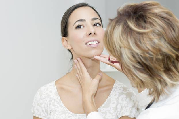 Mature female doctor examining her patient