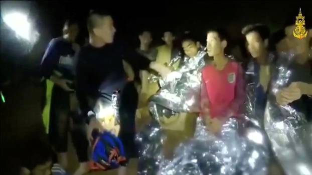 Boys from the under-16 soccer team trapped inside Tham Luang cave greet members of the Thai rescue team in Chiang Rai, Thailand