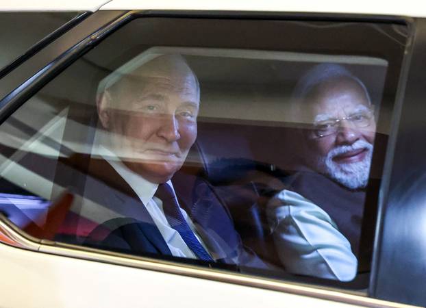 Russian President Vladimir Putin and Indian Prime Minister Narendra Modi arrive for an informal dinner in New Delhi