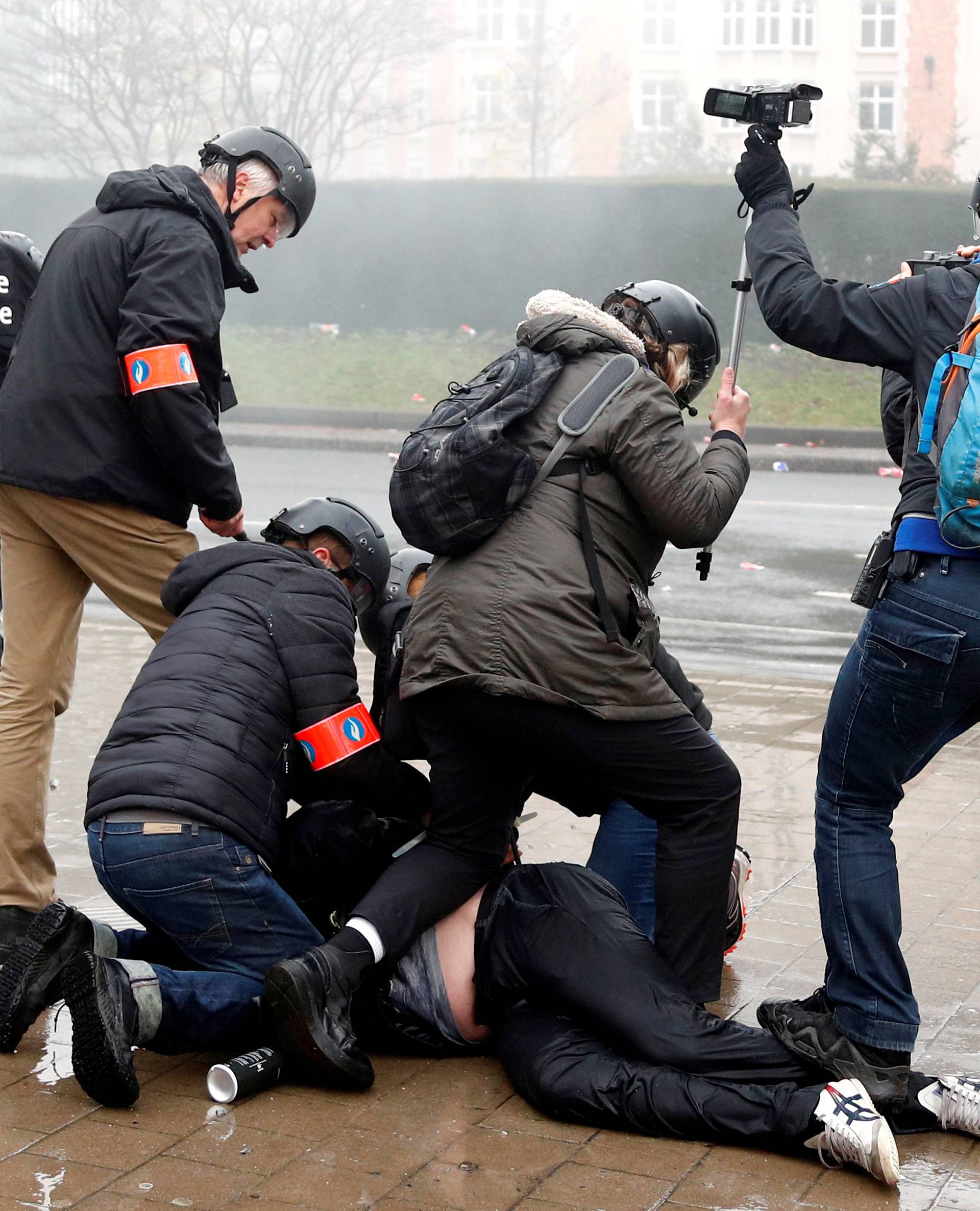 Belgian Federal Police officers detain a far-right supporter during a protest against Marrakesh Migration Pact in Brussels