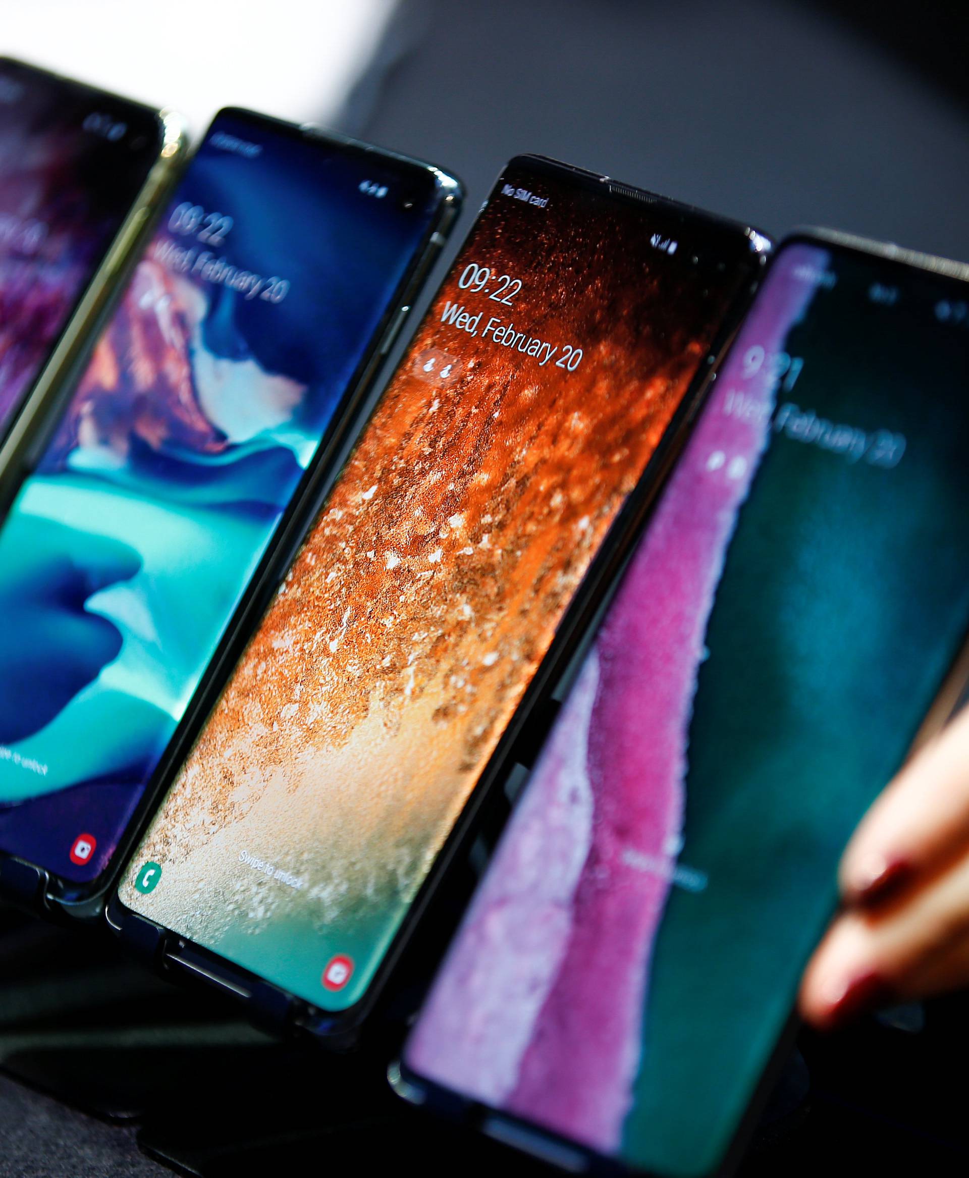 A Samsung employee arranges the new Samsung Galaxy S10e, S10, S10+ and the Samsung Galaxy S10 5G smartphones at a press event in London