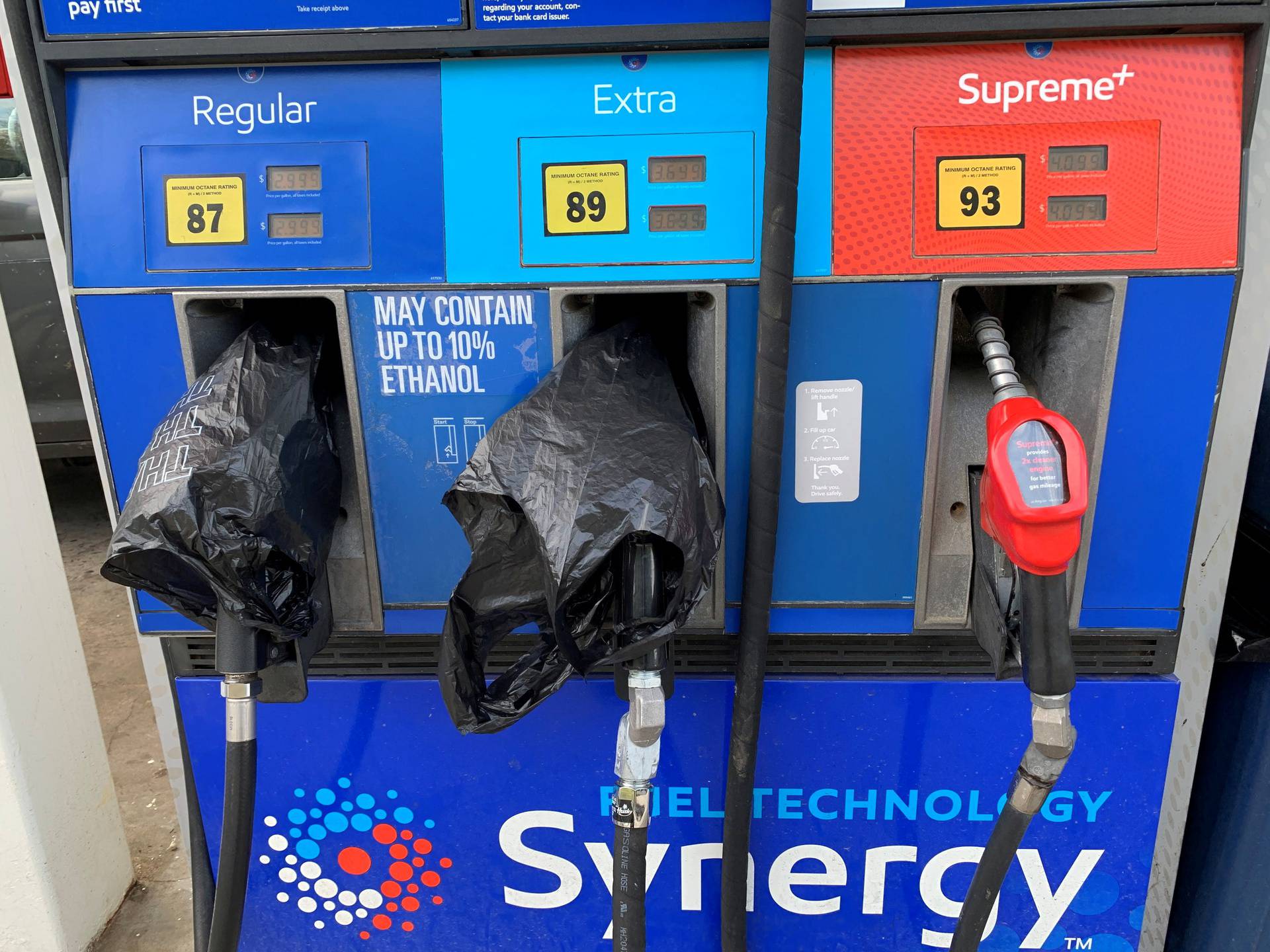 Two out of service fuel nozzles are covered in plastic on a gas pump at a gas station in Waynesville, North Carolina, after a gasoline supply crunch caused by the Colonial Pipeline hack