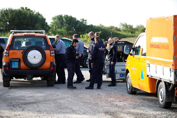 Members of The Danish Emergency Management Agency (DEMA) (Danish: Beredskabsstyrelsen) prepare to assist police at Kalvebod Faelled in Copenhagen