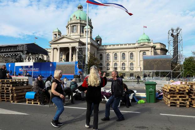 People attend a rally in support of policies of the President Aleksandar Vucic