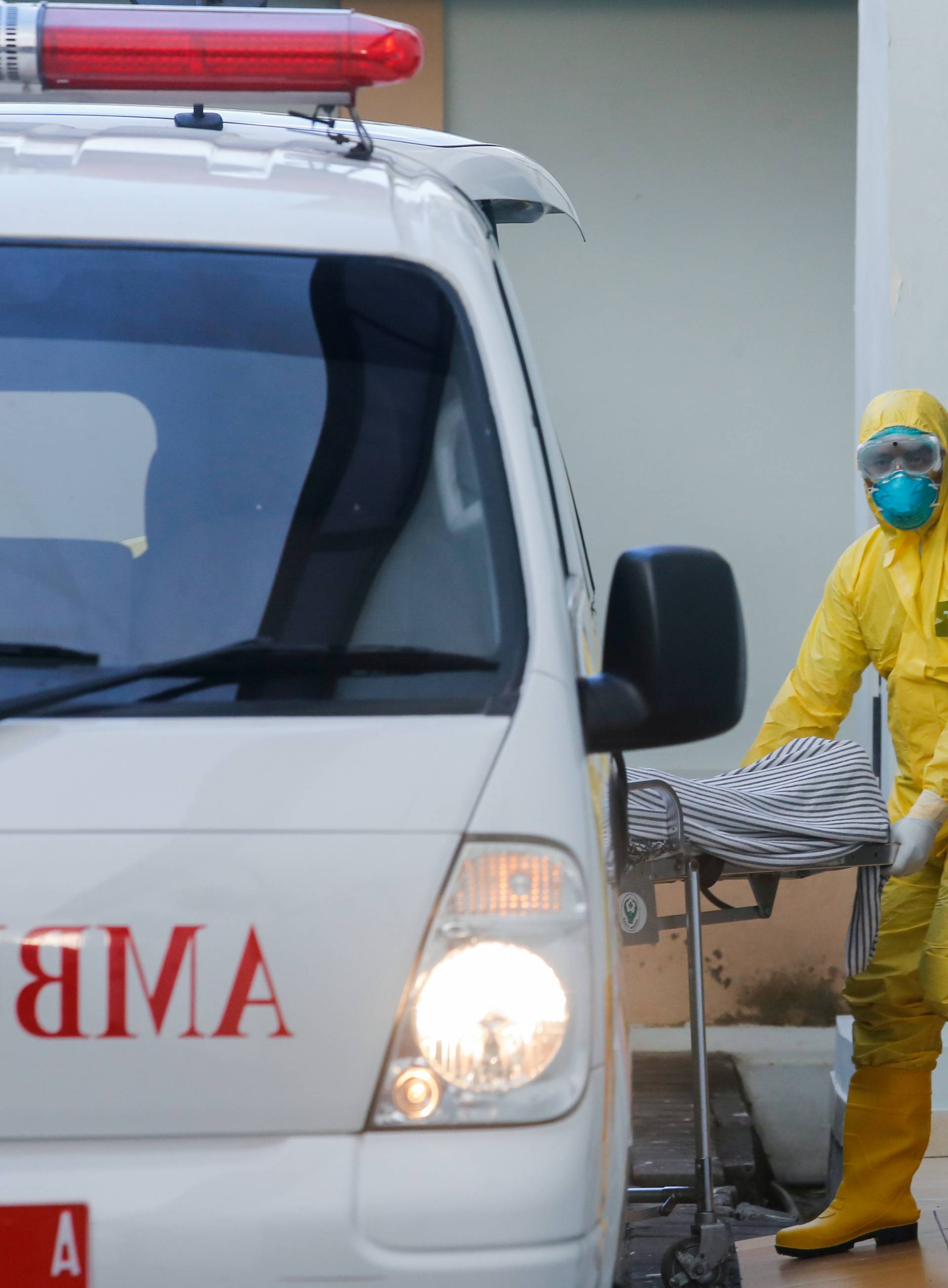 A medical worker wearing protective suits pulls a stretcher from an ambulance to the isolation room for patients affected coronavirus disease (COVID-19) at Sanglah Hospital in Denpasar, Bali