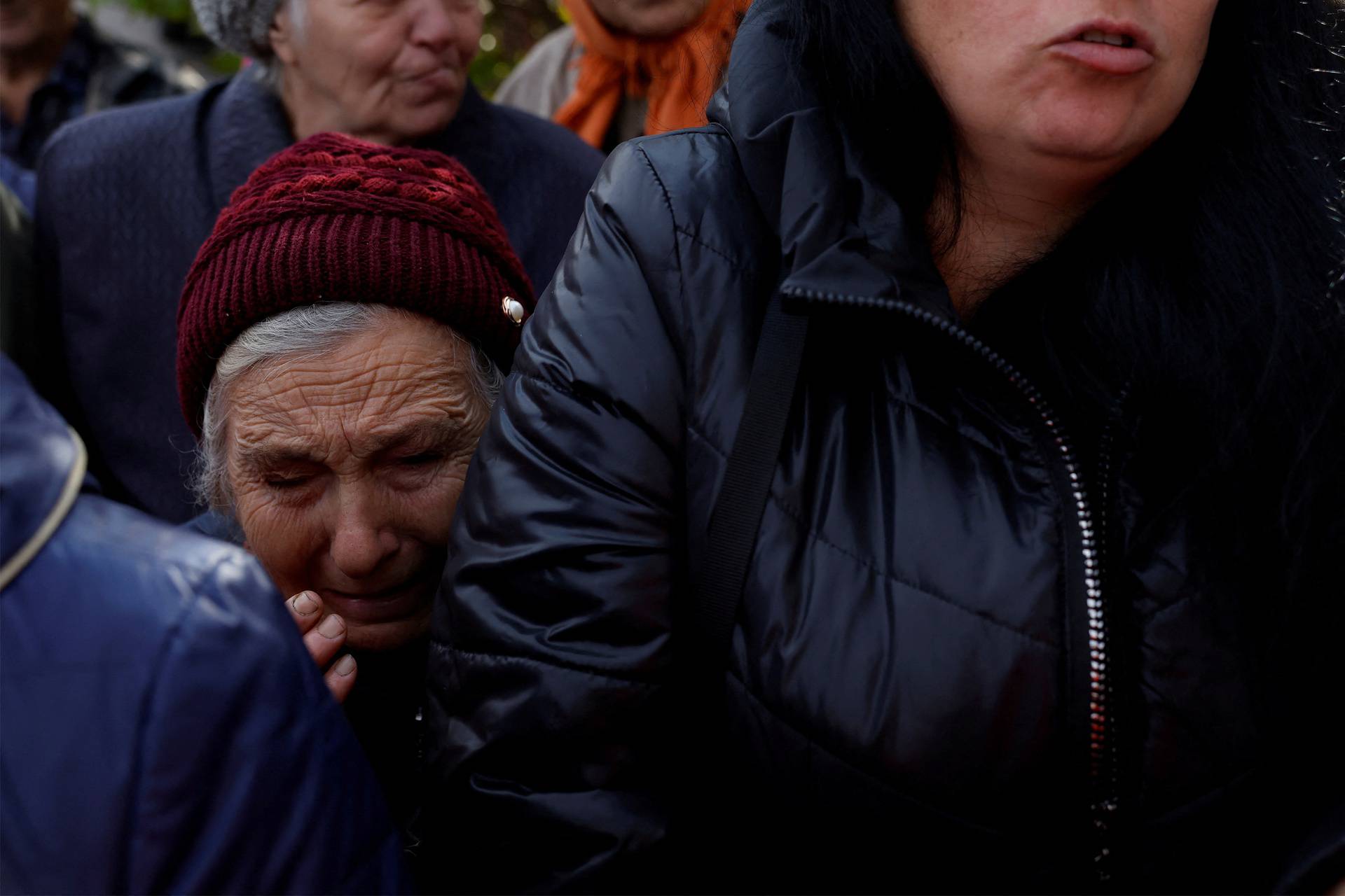 People queue to receive pensions and state aid, in Savyntsi