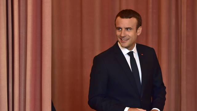 French President Emmanuel Macron arrives to vote at a polling station in the second round parliamentary elections in Le Touquet