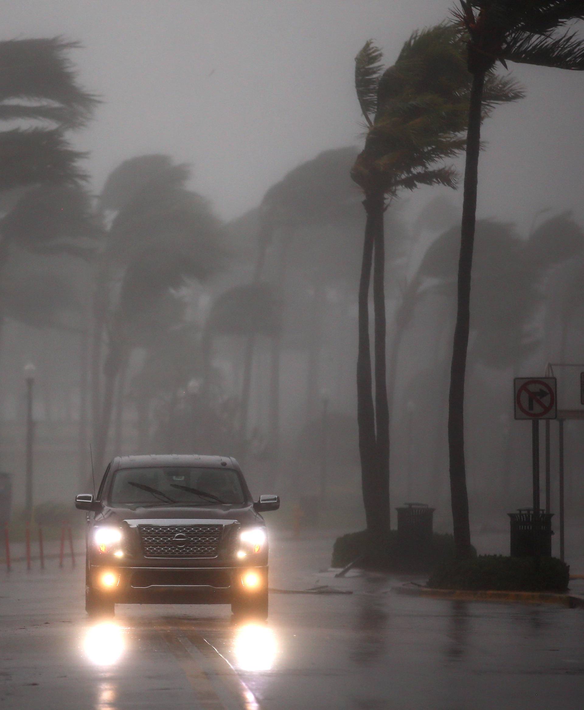 A vehicle drives along Ocean Drive in South Beach as Hurricane Irma arrives at south Florida, in Miami Beach