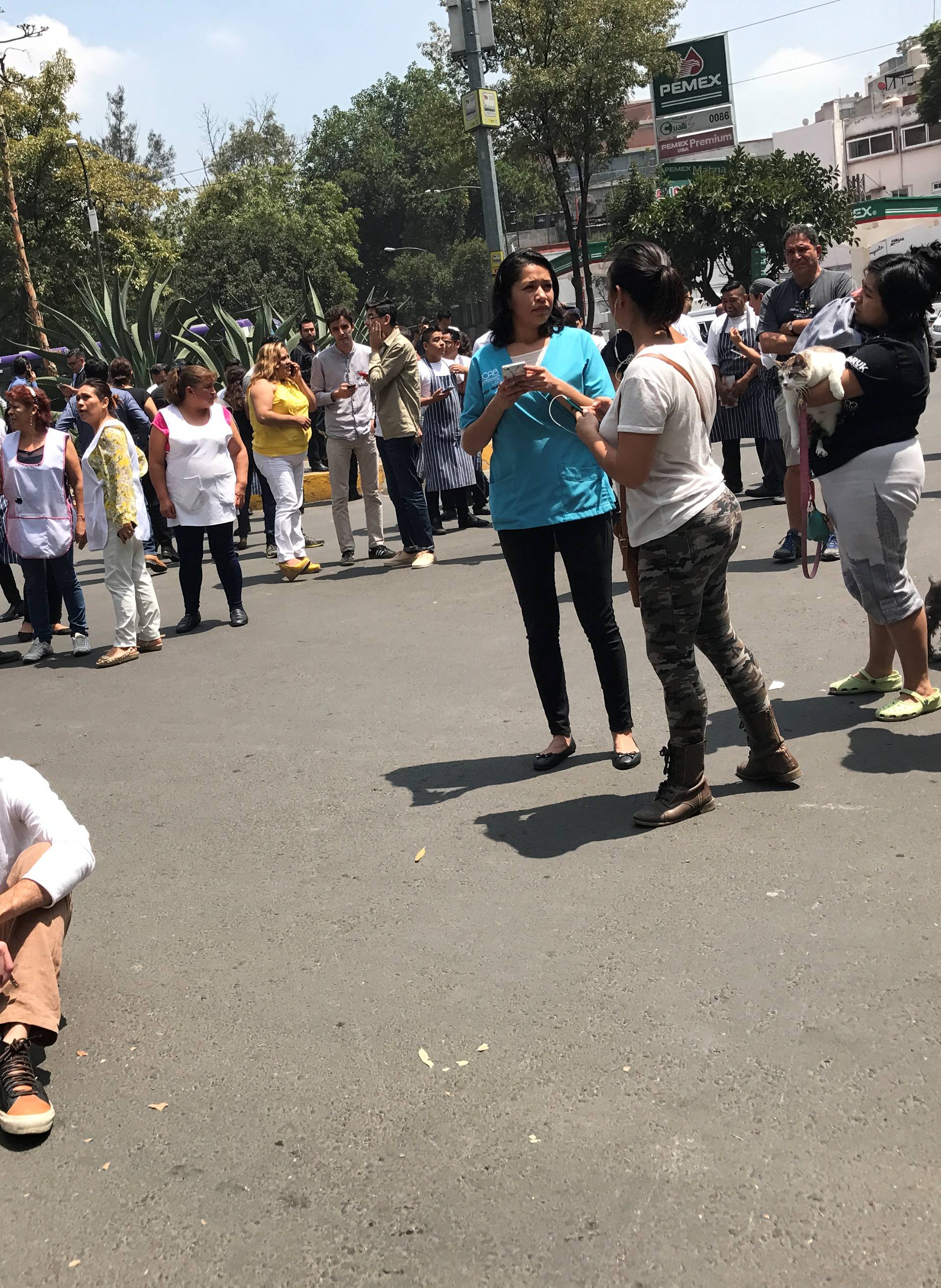 People react after an earthquake hit in Mexico City