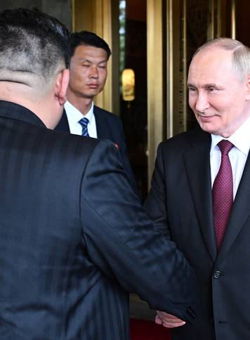 Russian President Vladimir Putin meets with North Korean leader Kim Jong Un in Beijing