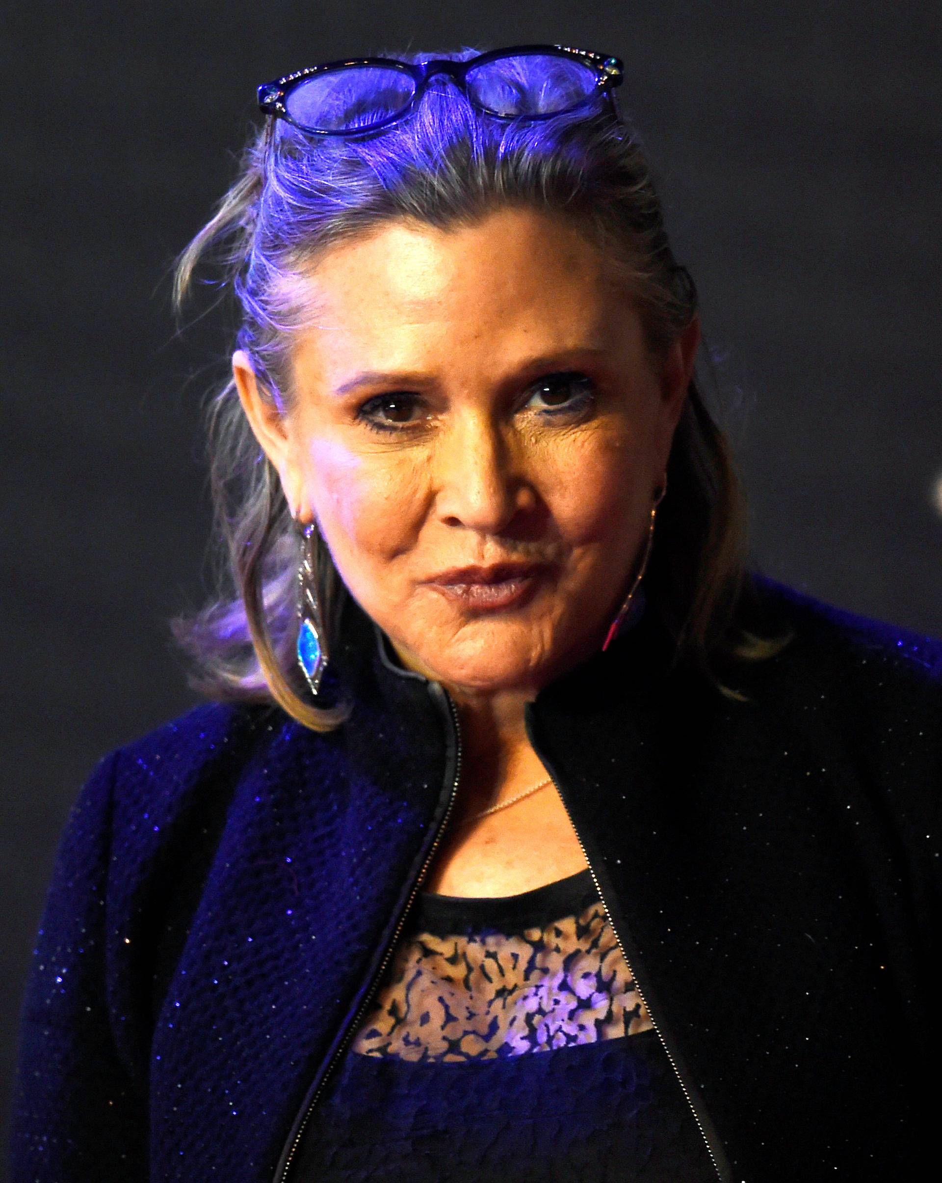 FILE PHOTO - Carrie Fisher poses for cameras as she arrives at the European Premiere of Star Wars, The Force Awakens in Leicester Square, London