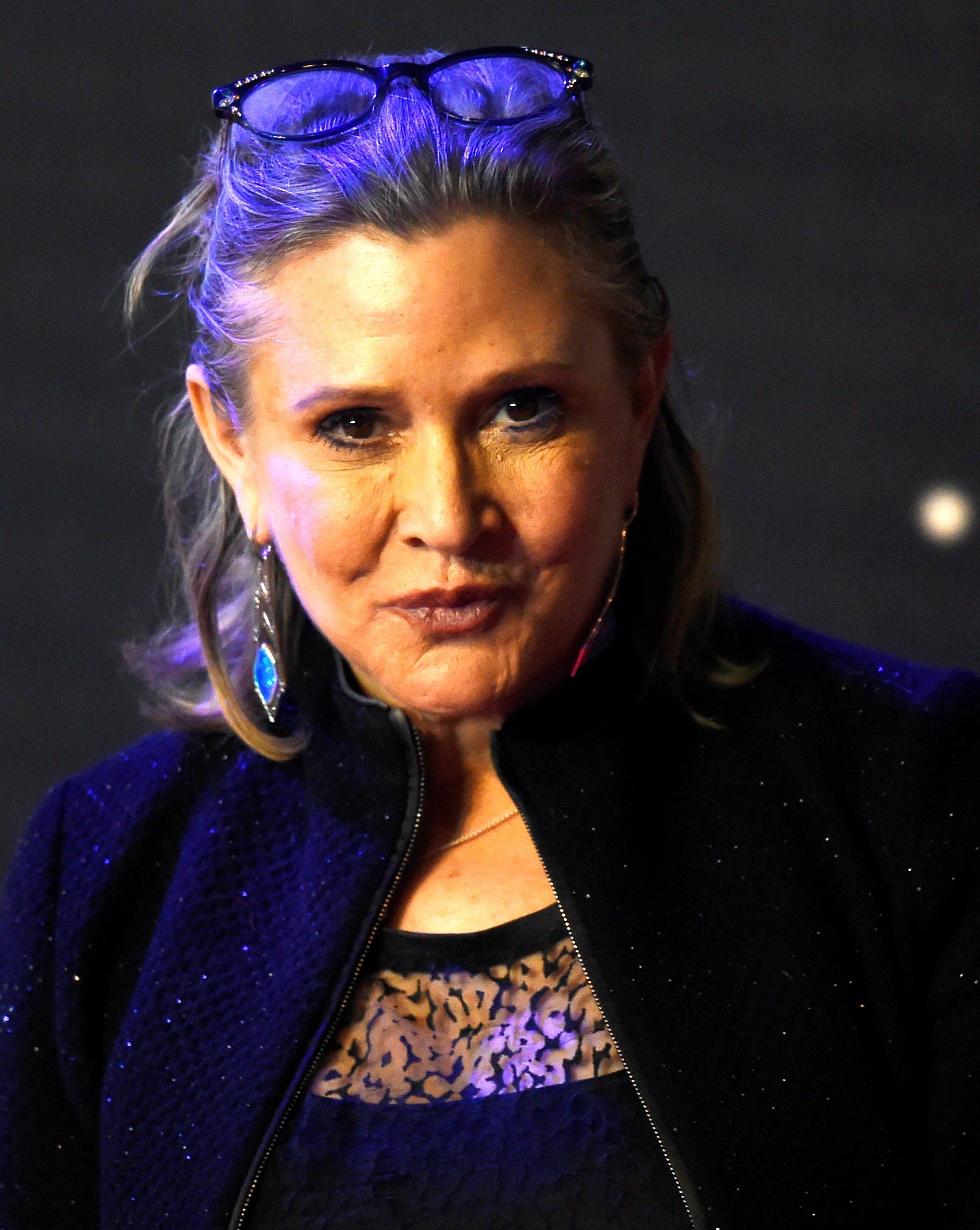 FILE PHOTO - Carrie Fisher poses for cameras as she arrives at the European Premiere of Star Wars, The Force Awakens in Leicester Square, London