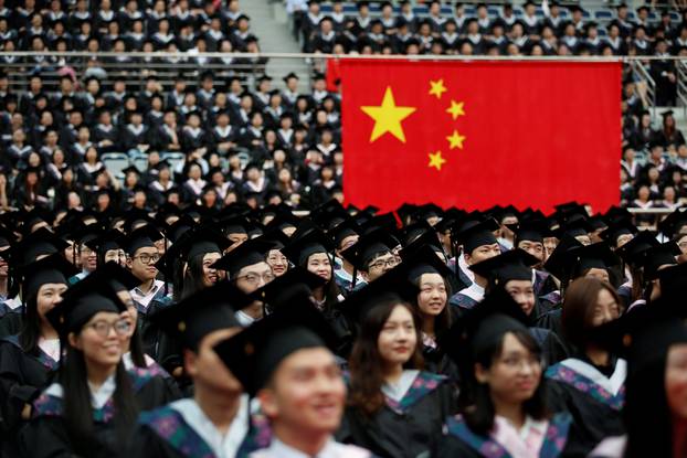 Students attend a graduation ceremony at Fudan University in Shanghai