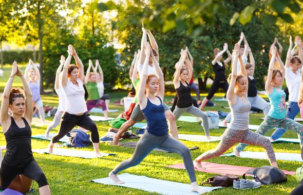 Big,Group,Of,Adults,Attending,A,Yoga,Class,Outside,In