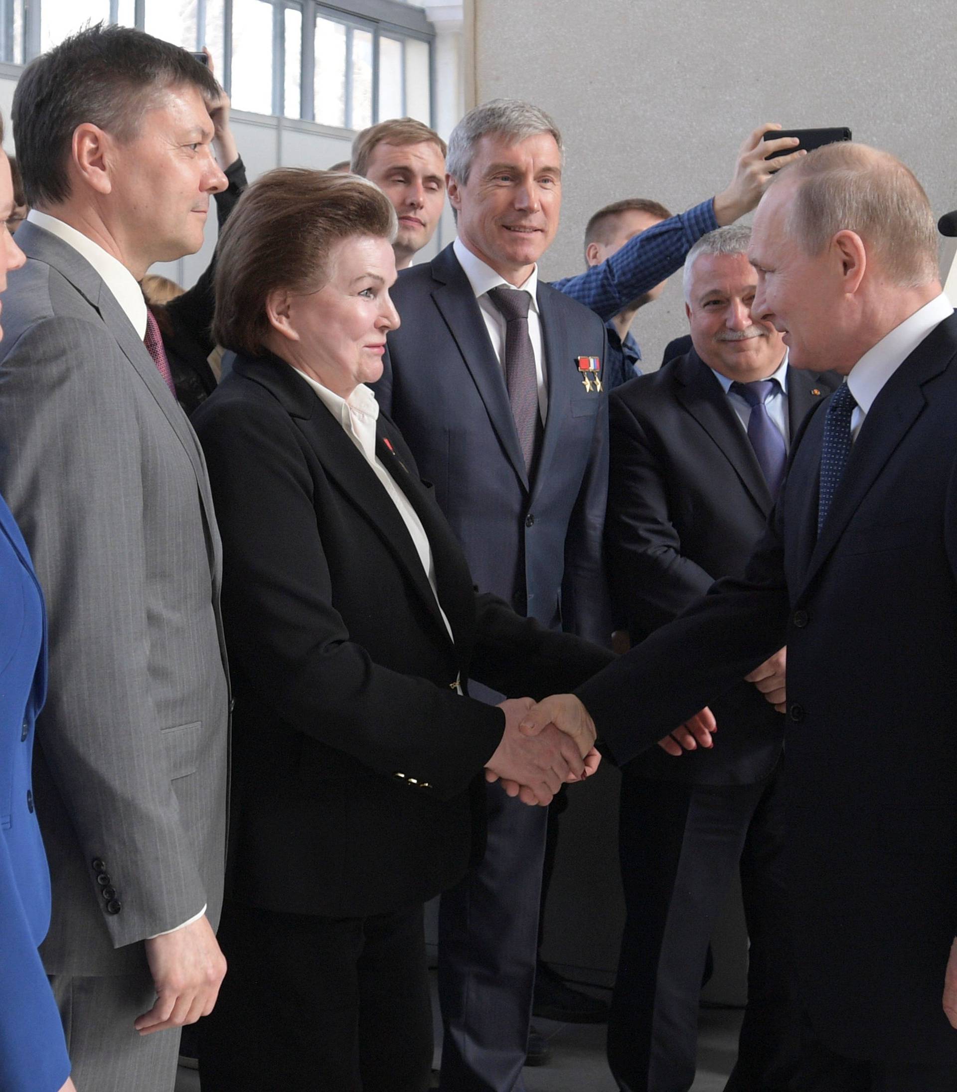 Russian President Vladimir Putin greets Valentina Tereshkova, the first woman cosmonaut, during a visit to the historical Space Pavilion opened after a renovation in Moscow