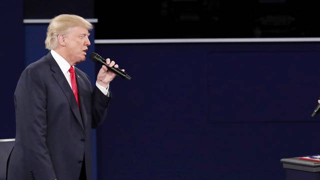 Republican U.S. presidential nominee Donald Trump and Democratic U.S. presidential nominee Hillary Clinton speak during their presidential town hall debate at Washington University in St. Louis