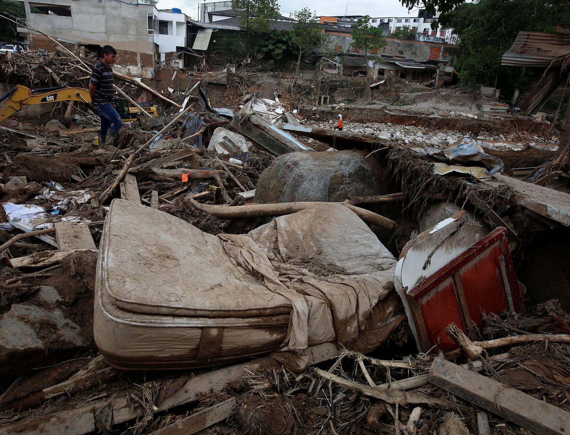 A man looks at a destroyed area, after flooding and mudslides caused by heavy rains leading several rivers to overflow, pushing sediment and rocks into buildings and roads, in Mocoa