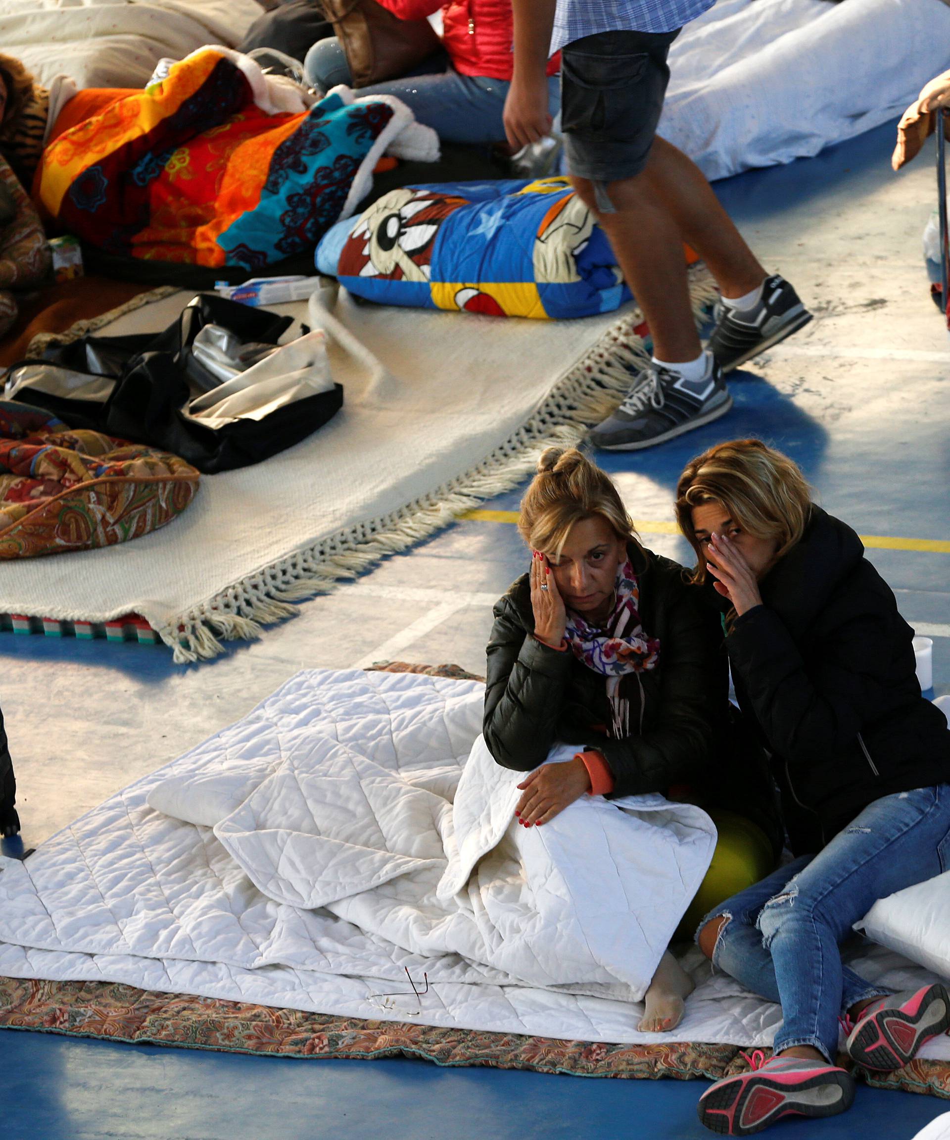 People rest following an earthquake in Amatrice