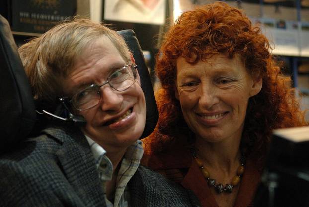 FILE PHOTO: British astrophysicist Professor Stephen Hawking and his wife Elaine (R) visit the stand of German bookseller Rowohlt at the Frankfurt book fair
