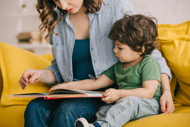 Cropped,View,Of,Mother,And,Son,Reading,Book,Together