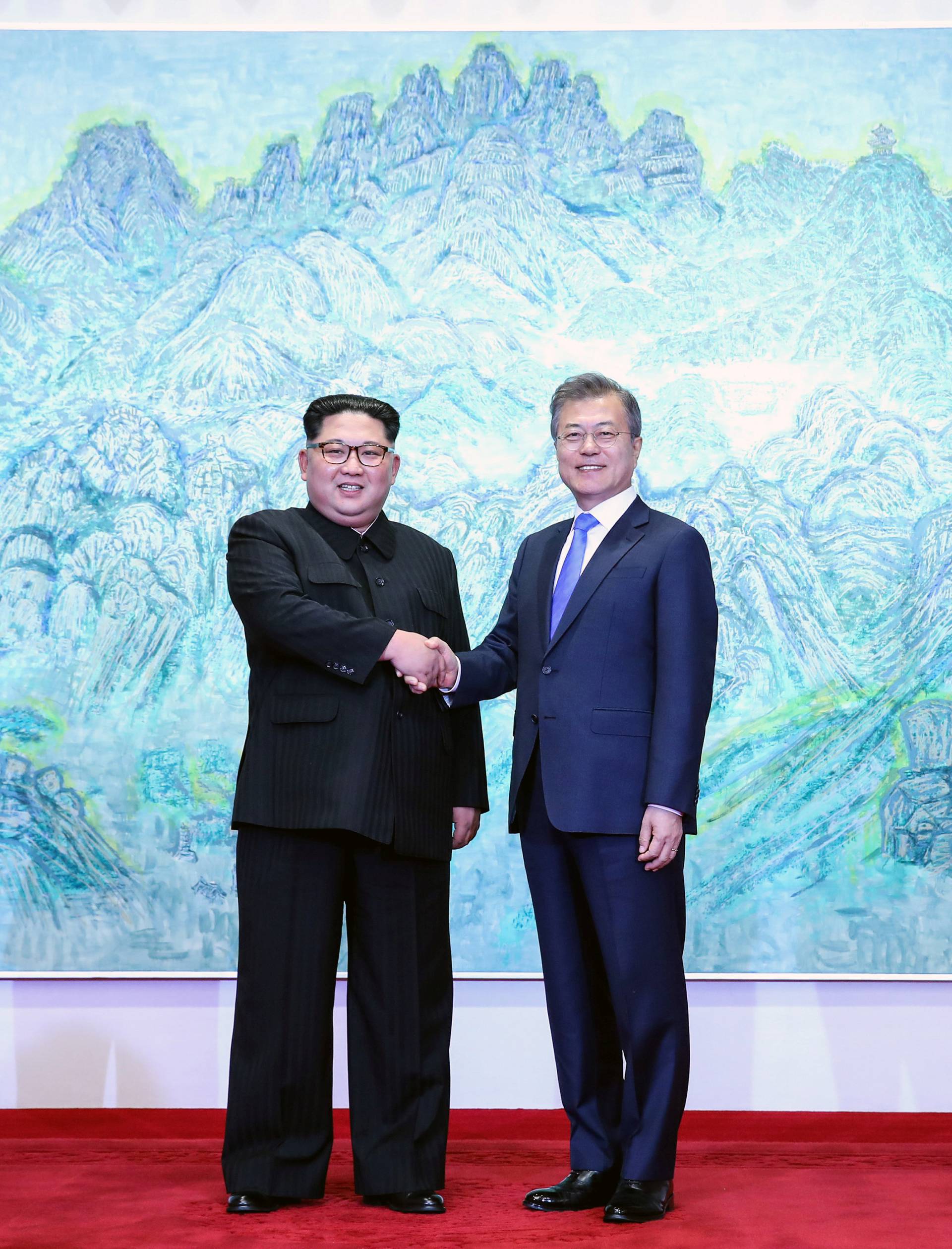 South Korean President Moon Jae-in shakes hands with North Korean leader Kim Jong Un during their meeting at the Peace House