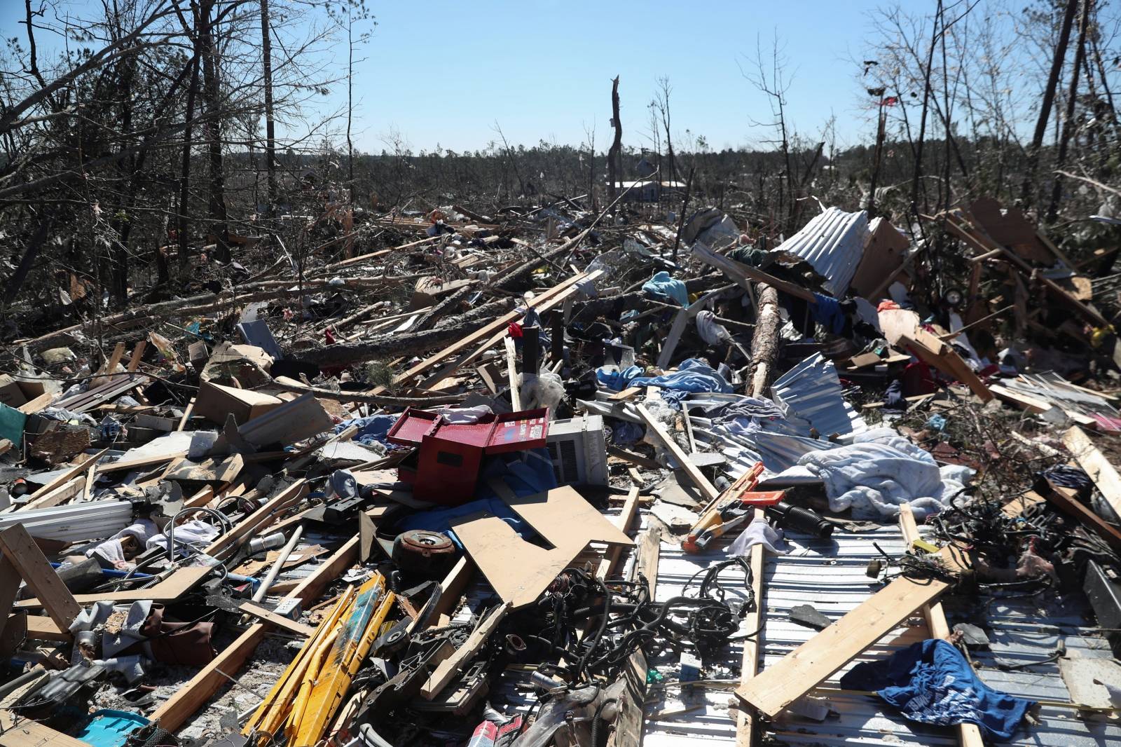 Debris lays outside a house devastated after two deadly back-to-back tornadoes, in Beauregard, Alabama