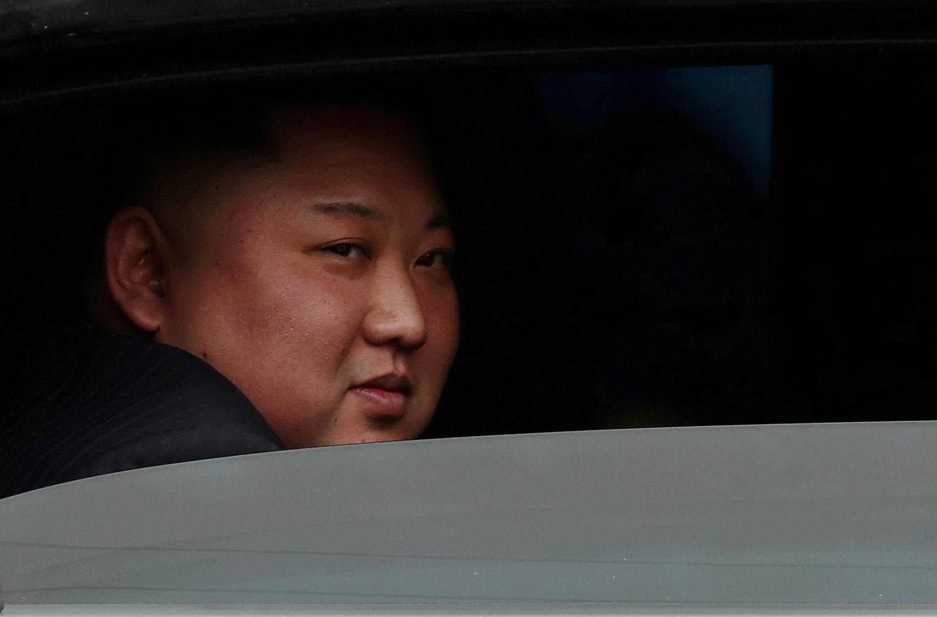 FILE PHOTO: North Korea's leader Kim Jong Un sits in his vehicle after arriving at the Dong Dang railway station