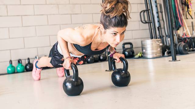 Woman,Making,Push,Ups,On,The,Kettle,Bells,In,A