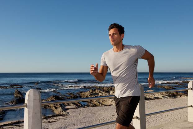 Portrait,Of,Active,Middle,Age,Man,Jogging,Outside,By,Sea
