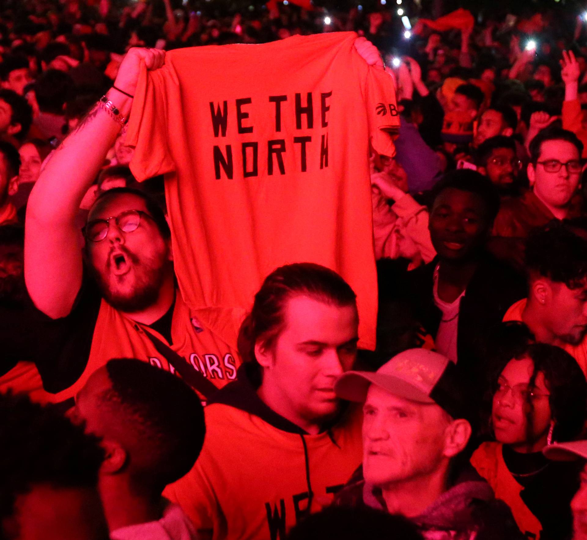 Fans celebrate their win in Game 6 of the NBA basketball Finals between the Toronto Raptors and the Golden State Warriors on a large screen in a fan zone in Montreal