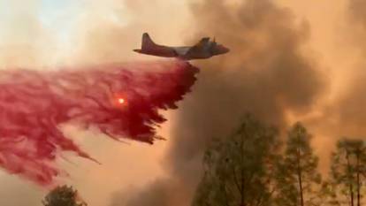 Fire retardant is dropped on a lightning complex fire in Berryessa Estates