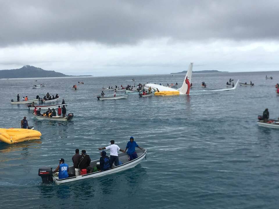 People are evacuated from an Air Niugini plane crashed in the waters in Weno, Chuuk, Micronesia