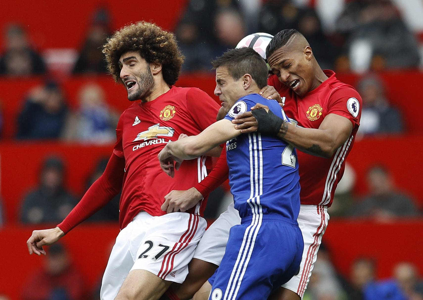Manchester United's Marouane Fellaini and Antonio Valencia in action with Chelsea's Cesar Azpilicueta