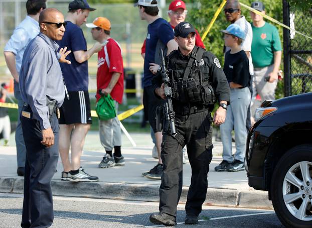 Police survey a shooting scene after a gunman opened fire on Republican members of Congress during a baseball practice in Alexandria, Virginia