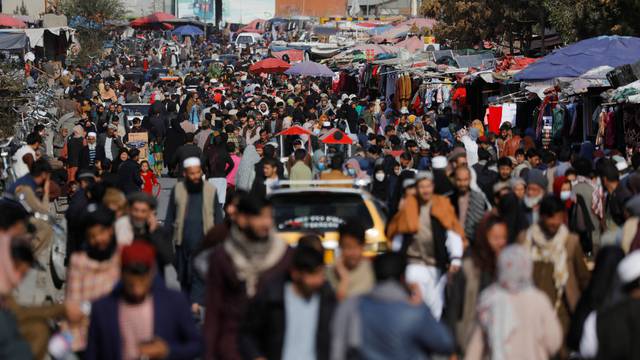 People walk in a street in Kabul